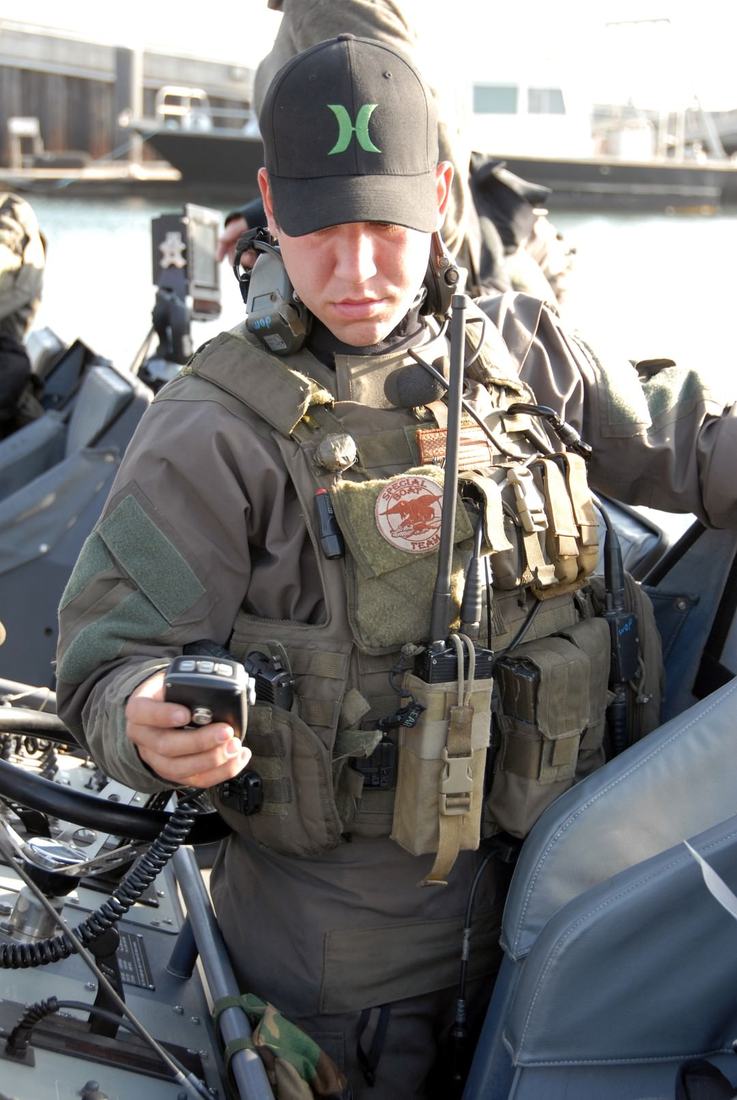 A Naval Special Warfare operator checking communications gear during a training run