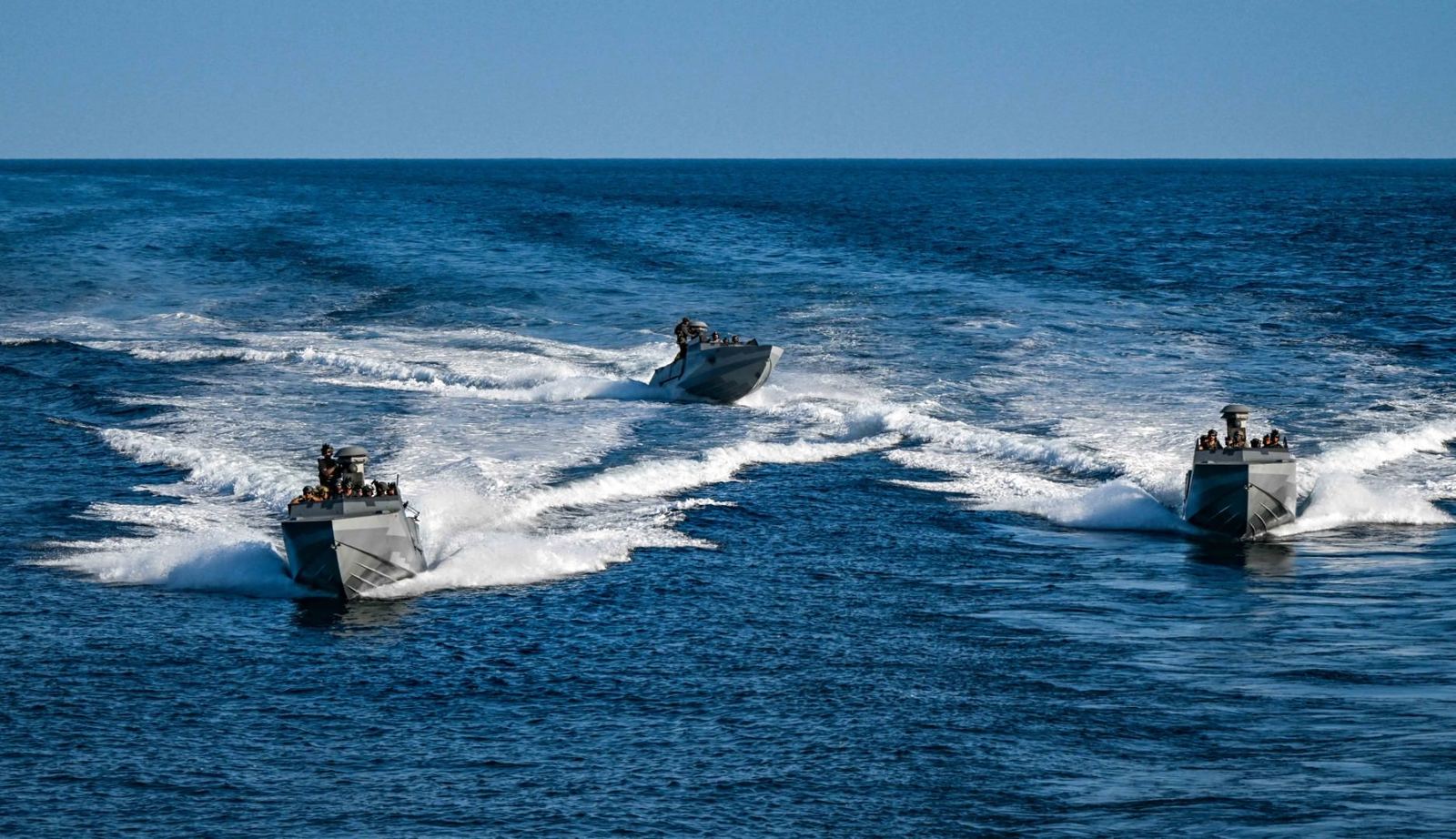 Special warfare craft running in formation across open water