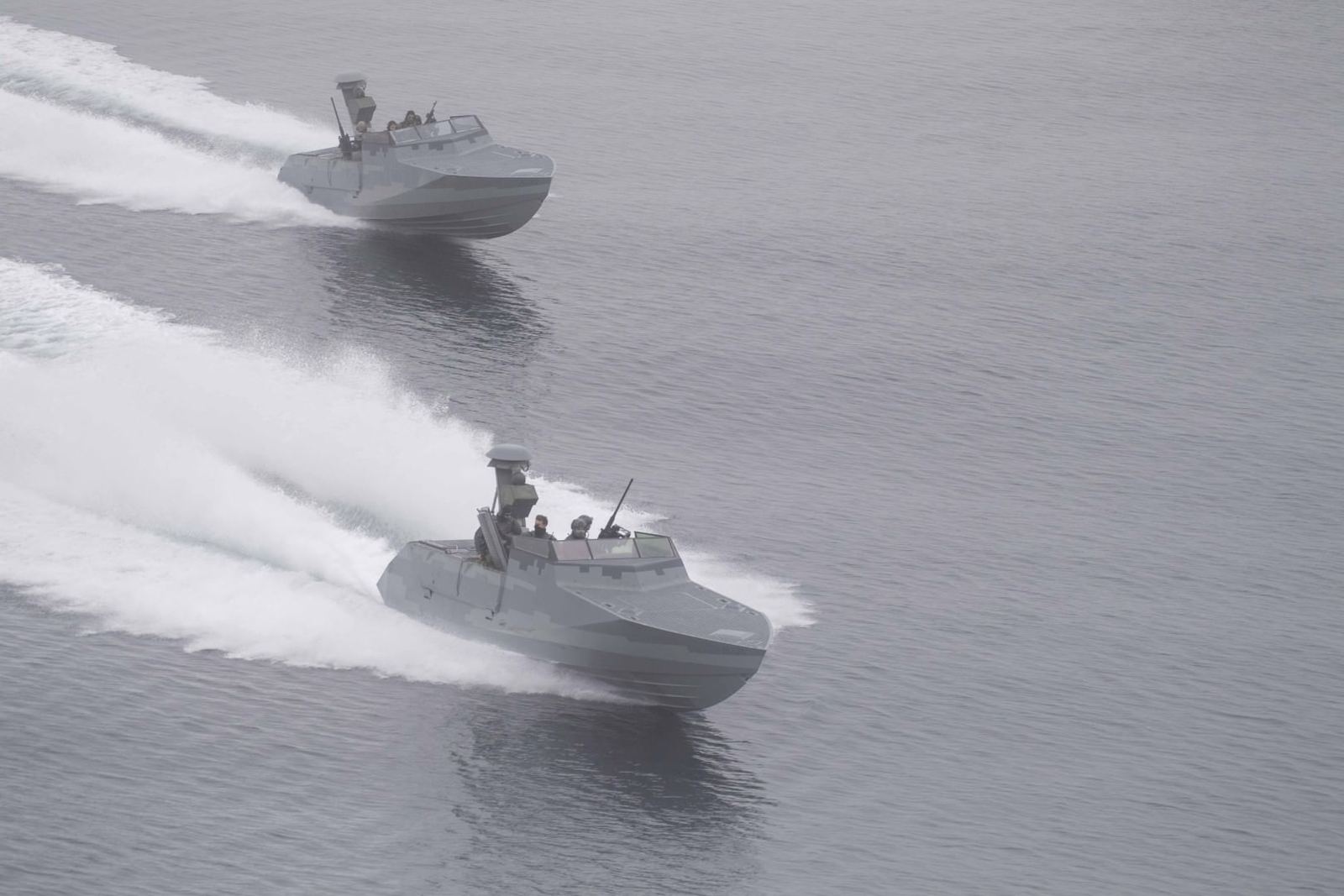 Two special warfare craft running in company on open water