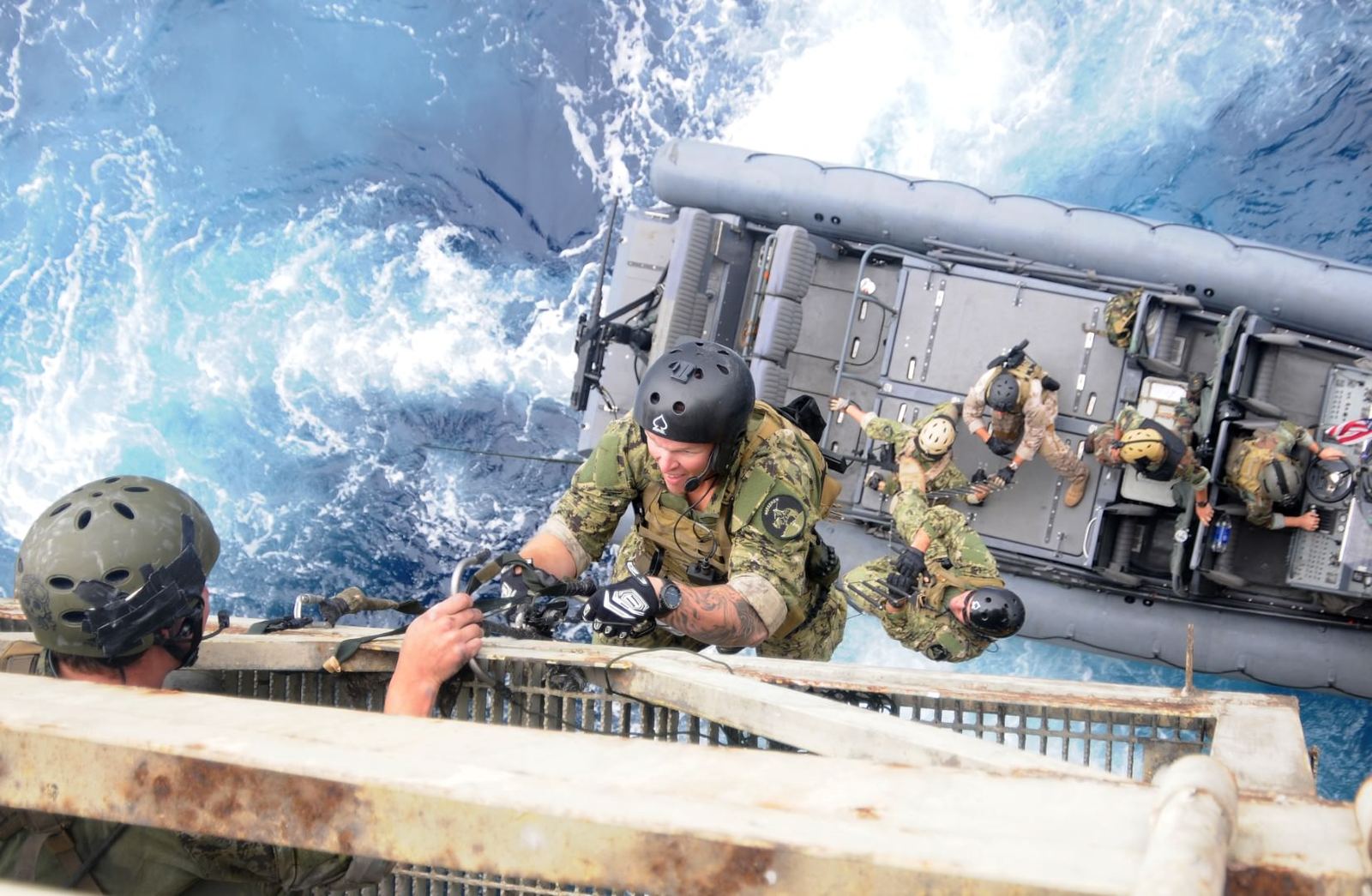 Operators working from a small boat during a shipboarding exercise