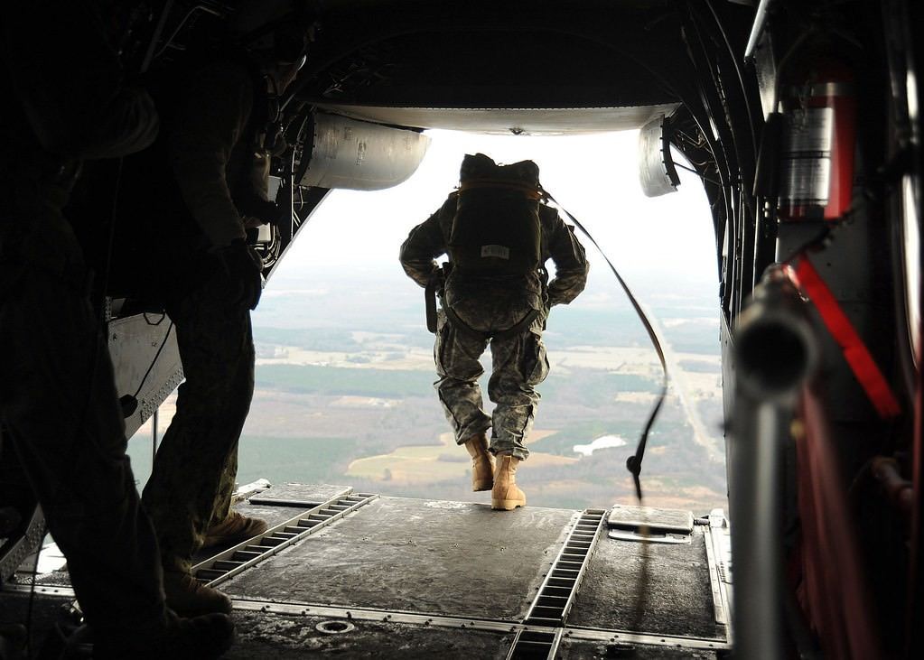 An operator in the door of an aircraft before a static line jump